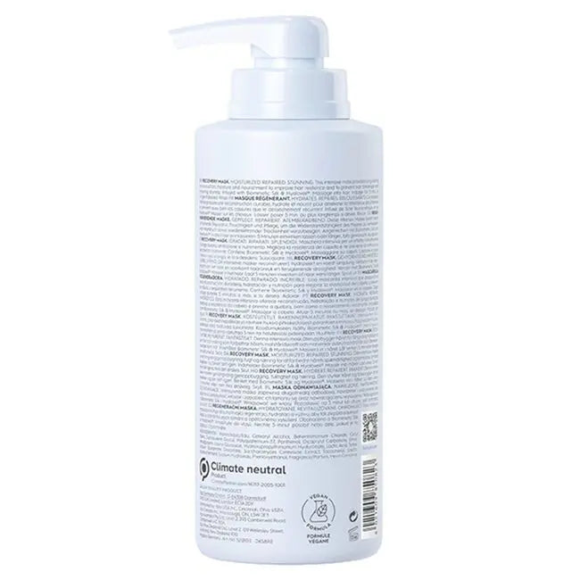 White bottle with pump and label on a white background