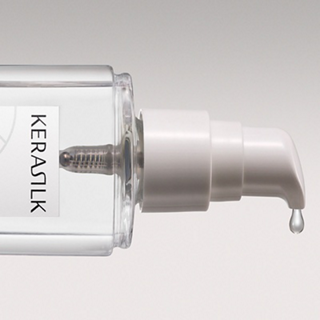 Close-up of a Kerastik hair care product with dropper on a light gray background