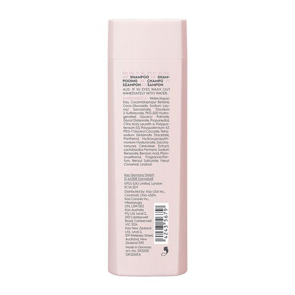 Back of a pink shampoo bottle with text and a barcode on a white background