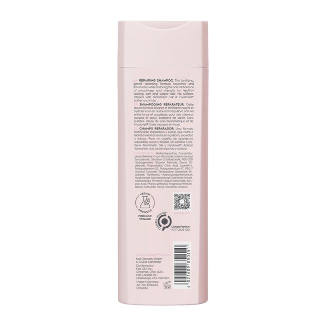 Back view of a pink shampoo bottle with text and logos on a white background