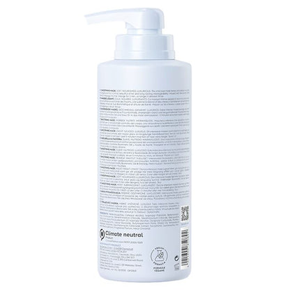 White bottle with pump and label on a white background