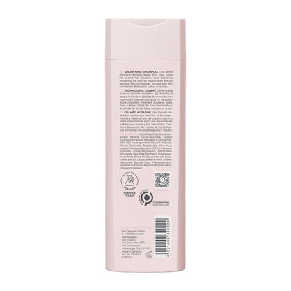 Back view of a pink shampoo bottle with text and logos on a white background