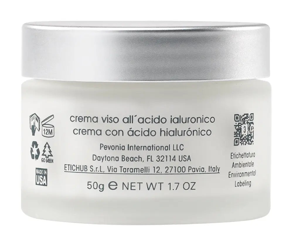 White jar of facial cream with silver lid on a white background