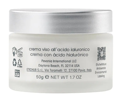 White jar of facial cream with silver lid on a white background