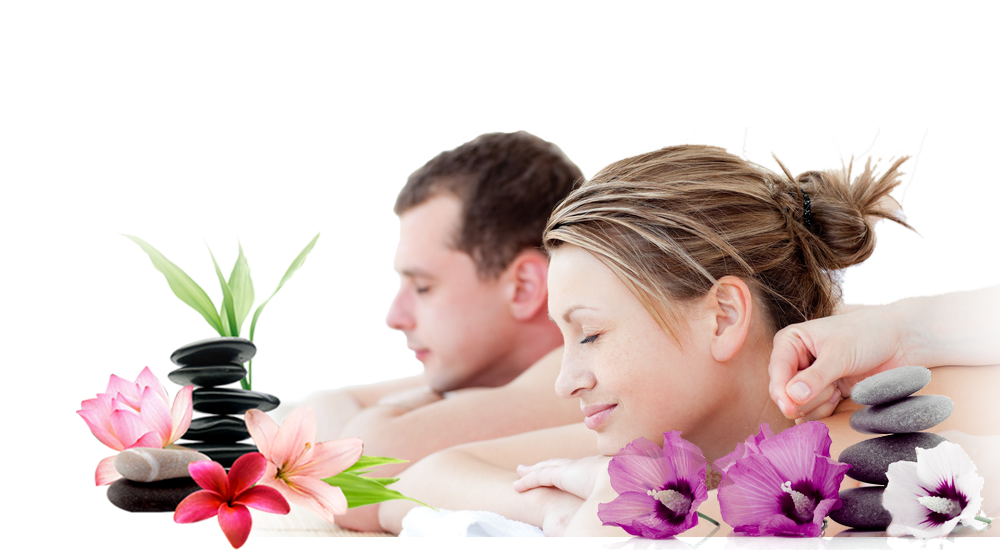 Man and woman receiving a massage with flowers and stones on a white background