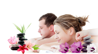 Man and woman receiving a massage with flowers and stones on a white background