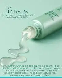 Lip balm being squeezed onto a light green background