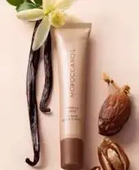 Bottle of Moroccanoil product with vanilla bean, date, and vanilla pod on a white background