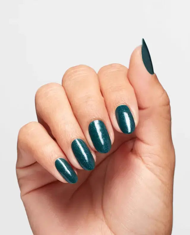 Hand with teal nail polish on a light gray background